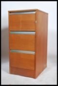 A 1970's retro teak wood 3 drawer upright pedestal office filing cabinet. Each drawer with