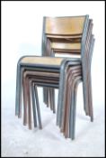 A stack of six vintage mid 20th century industrial tubular grey metal framed stacking chairs with