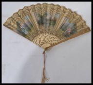 A late 19th / early 20th century bone and silk hand fan having hand painted scenes of a courting