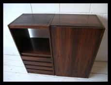A 1970's retro teak wood veneer wall cabinet being made by Hille UK. In good vintage condition