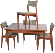 A good mid century Danish teak wood dining table being raised on chamfered tapering edge legs with