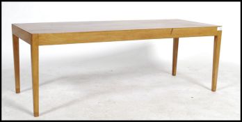 A vintage 20th century Vanson century teak wood coffee table raised on angular legs with rectangular