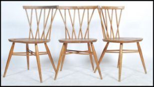 A set of three fantastic vintage mid 20th Century Ercol Windsor beech and elm cross back candlestick