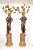 A decorative pair of 20th century large Venetian style Blackamoor floor standing standard lamps.