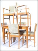 A good mid century Gordon Russell solid golden oak draw leaf square refectory dining table