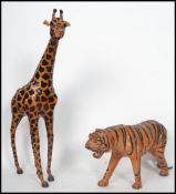 A pair of 20th century shop display leather covered hand painted giraffe and tiger, likely of