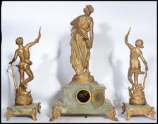 A 19th century clock and garniture set raised on g