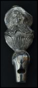 A silver plated whistle in the form of a lady. Bai