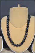 A vintage freshwater black pearl necklace strand.