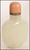 A 19th century Chinese white / light green jade snuff bottle with red coral top complete with the
