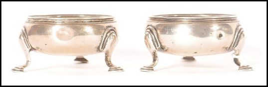 A pair of mid 18th century George II Georgian silver hallmarked table salts of circular form