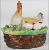 A 19th Century Victorian Staffordshre china egg crock in form of a chicken protecting its eggs on