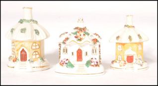 A group of 3 19th century pastille burners in the shape of cottages, all with umbrella style roofs