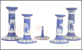 A 19th century Wedgwood Jasperwatre cameoware dressing table set consisting of two pairs of cobalt