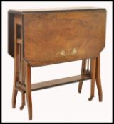 An Edwardian rosewood and marquetry bone inlaid drop leaf Sutherland table. The table being raised