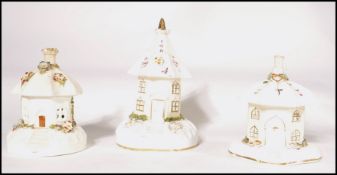 A group of 3 19th century pastille burners in the shape of cottages, all with umbrella style roofs