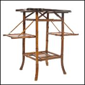 A 19th century Aesthetic movement lacquered bamboo side - drinks table. The table with fold down