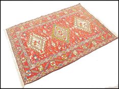 A good silk and wool South West Persian Shiraz Qashqai rug with red ground, central 3 diamond shaped