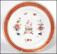 An 18th century Chinese porcelain armorial plate having geometric painted border with tall ship