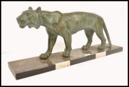 A 1930's Art Deco large verdigris spelter tiger. Raised on a veined marble plinth with black and