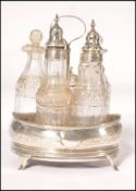 An early 19th century Georgian silver hallmarked cruet stand with a set fo cut glass bottles with