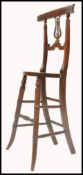A 19th century Victorian beech and elm wood harpists - musicians chair being raised on turned legs