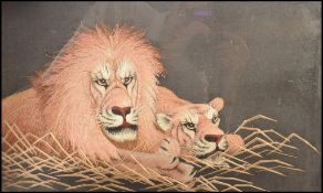 A Meiji period Japanese silk embroidery of a lion and lioness resting among grass. Highly detailed