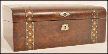 A 19th century Victorian French Amboyna burr wood writing slope having a tooled purple leather inner