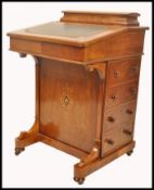 A 19th century VIctorian mahogany inlaid davenport desk. The hinged top with tooled leather