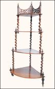A Victorian Regency mahogany whatnot etargere of waterfall form being raised on turned legs with