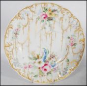 A Swansea porcelain plate painted with sprays and swags of gilded husks with floral sprays and