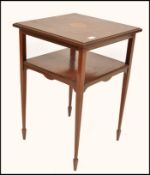 A 19th century Georgian mahogany sunburst inlaid side table. Raised on slender tapering legs with