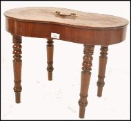 An 18th / 19th century regency mahogany kidney shaped bidet being raised on turned legs with
