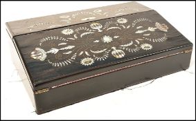 A 19th century coromandel wood writing slope having mother of pearl and abalone inlay. Hinged top
