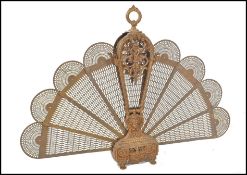 A large early 20th century French heavy gilded bronze peacock style firescreen. The heave set