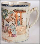 A 19th century Chinese export porcelain mug being decorated with scenes of family and pagoda