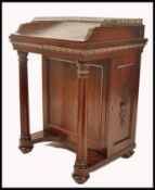 A 19th century Regency rosewood davenport. The top with inset leather writing skiver having hinged