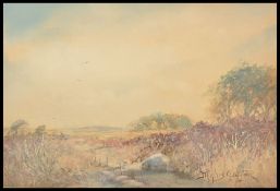 Joseph Hughes Clayton (1870 - 1930) A framed and glazed watercolour landscape of a feeding sheep