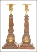 A pair of Masonic carved wooden souvenir candlestick with cast brass sockets, the base of each