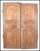 A pair of 18th century French chestnut / oak armoire panel doors. Each with fielded carved panels,