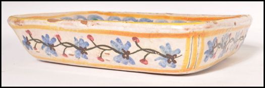 A late 19th century tin glazed earthenware rectangular bowl with polychrome decoration and central