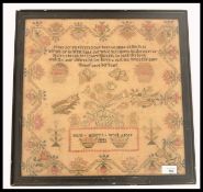 A 19th century needlepoint sampler dated 1843 by Maria Masleys age 9. The sampler panel with