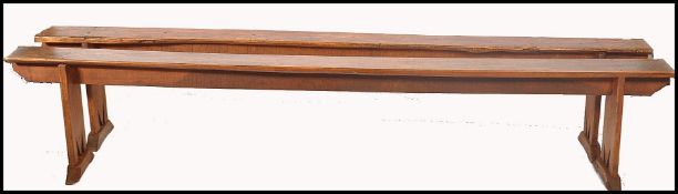 An exceptional pair of 19th century French fruitwood polished refectory pig benches. Each with