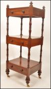 A Victorian 19th century solid mahogany whatnot etargere stand, Raised on bun feet with castors