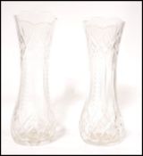 A pair of 20th century cut glass crystal vases, Each being facet cut with a further unusual