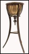 A late 19th century brass and mahogany planter stand / jardiniere. Raised on sabre supports with