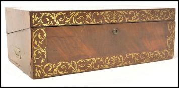 A 19th century Georgian mahogany and brass inlaid writing slope having a plain armorial cartouche to