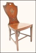 A 19th century Georgian solid mahogany hall - butlers chair being raised on square tapering legs