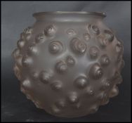 An early 20th century opaque Lalique Palissy opalescent glass vase being decorated with shells