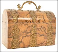 A 19th century walnut dome topped stationary box having brass bounding with shaped brass drop handle
